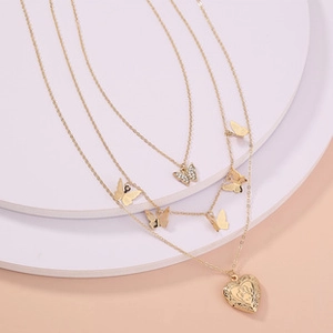 Three-layer gold necklace with butterfly charms and an embossed heart pendant detail