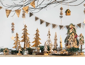 Close-up of wooden Christmas tree ornaments with natural pine cones and star details