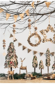Rustic Christmas decor set featuring birch bark trees, wooden deer, and pine cone details