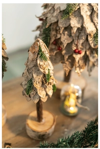 Detailed view of rustic birch bark Christmas tree with pine needles and red berries
