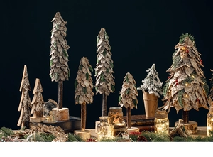 Close-up of rustic wooden Christmas trees with natural bark texture and warm LED lighting