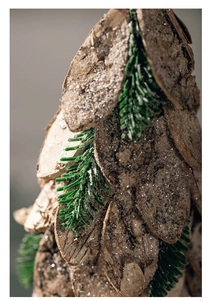 Macro detail of natural wood slices and pine needles with artificial snow for holiday decor