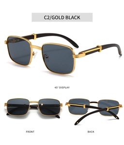 Detail view of square metal sunglasses with gold frames and dark wood-grain temples