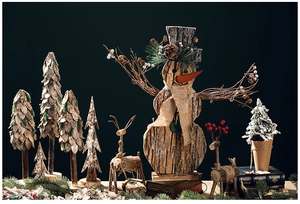Artistic collection of handcrafted bark snowmen, deer, and pine trees on dark background