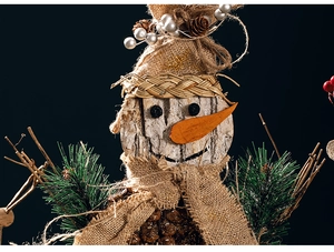 Detail of handmade wooden snowman with pine needles, burlap, and natural pine cones