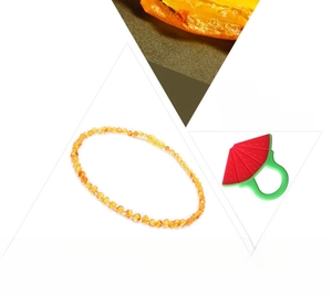 Baltic amber baby necklace with a silicone watermelon teether on white background