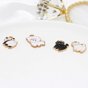 DIY gold alloy animal charms featuring cute panda and cats on a white ceramic plate