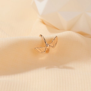 Macro shot of rose gold bat wing ear cuff made of vintage gothic style metal material