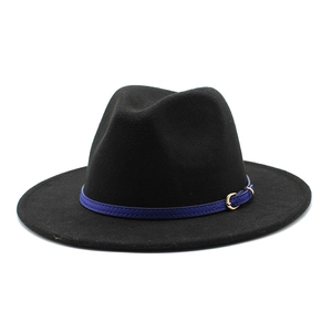 Close-up of black wool fedora featuring a blue leather band and golden buckle detail