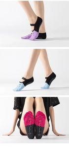 Detailed view of yoga socks in purple, blue, and pink with anti-slip grip and straps