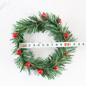 Christmas candle ring with red berries and green pine needles measuring 12cm outer diameter