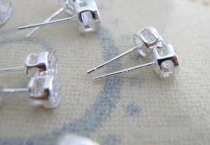 Macro detail of S925 sterling silver stud earring showing clear stone and hallmark