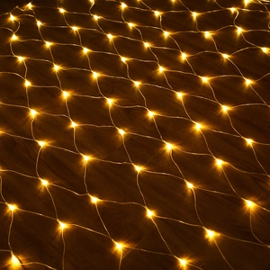 Detail of warm yellow LED net lights spread on dark wood floor for festive decoration