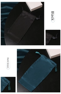 Detail of silk satin drawstring storage pouches in elegant black and dark green colors