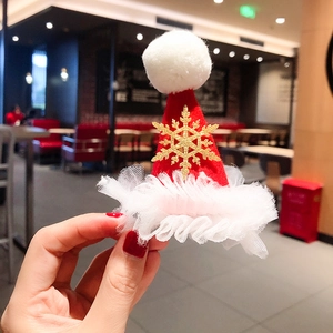 Christmas hair clip featuring a red velvet hat with white tulle and golden snowflake