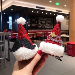 Detail of red sequin Christmas hat hair clips with Merry Christmas text and plush trim