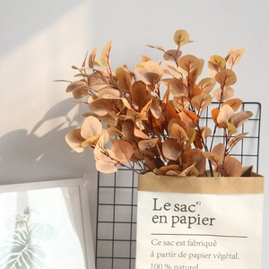 Nordic artificial eucalyptus leaves in autumn orange for stylish home interior decoration