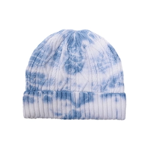 Close-up of blue and white tie-dye cable knit texture and folded cuff on beanie