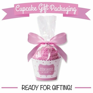 Pink cupcake-shaped coral fleece socks gift set with decorative bow in transparent packaging