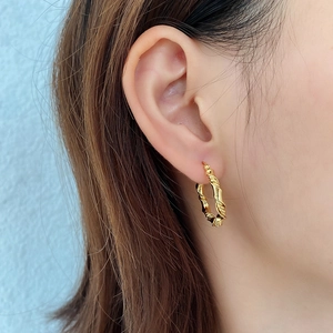 French style 925 sterling silver woven gold hoop earrings worn by a female model