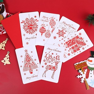 Detailed view of red Christmas cards featuring gold stamping reindeer and tree patterns