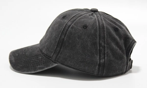 Side view of washed cotton baseball cap showing curved brim and panel stitching