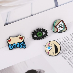 Set of four Picasso-style enamel pins including abstract faces and artistic eye motifs