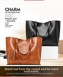 Detail of vintage oil wax leather bucket bags in brown and black with side tassels