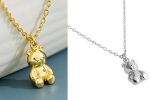 Detailed close-up of 3D bear pendant necklaces in gold and silver finish with cross chain
