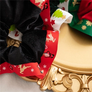 Detail of Christmas velvet scrunchie with reindeer patterns on a vintage tray