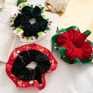 Velvet Christmas scrunchies with festive ribbons on an aesthetic book background