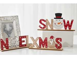 Close-up of Noel, Snow, and Xmas wooden tabletop decorations with hand-painted Santas