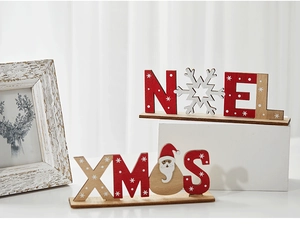 Detailed close-up of NOEL and XMAS wooden Christmas ornaments with painted Santa decor