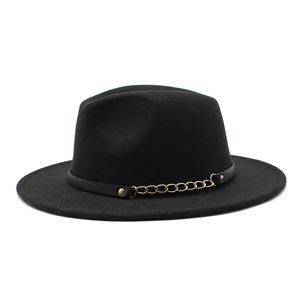 Detail of wool fedora hat with elegant black leather band and gold chain accent