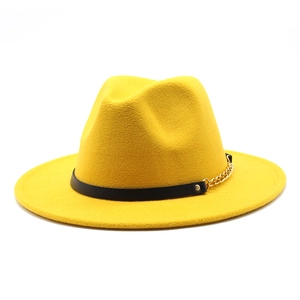 Detail of yellow wool fedora hat featuring a black leather band and gold chain accent