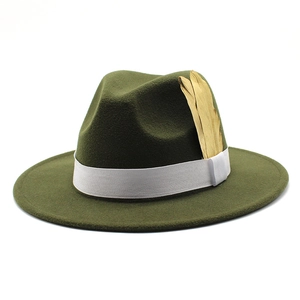 Detail of dark green fedora hat featuring a white ribbon and golden feather ornament