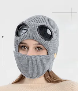 Detail of grey winter knit pilot hat with goggles and detachable mask with buttons