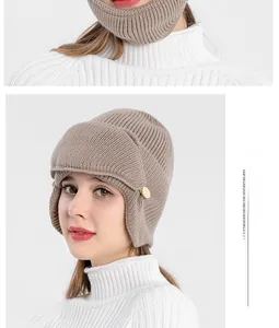 Close-up of thick khaki ribbed knit aviator hat with protective ear flaps and buttons