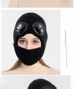 Detail of black winter knit aviator hat featuring integrated goggles and face mask