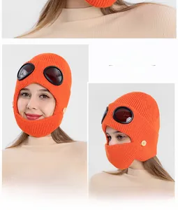 Orange pilot knit hat with integrated goggles and warm face mask detail view