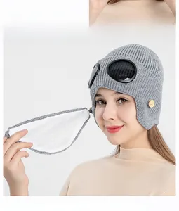 Detail view of grey aviator knit hat with goggles and matching face mask for winter warmth
