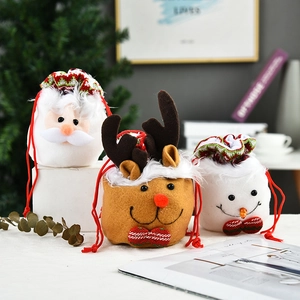 Close-up of Christmas drawstring candy bags featuring Santa, reindeer, and snowman designs