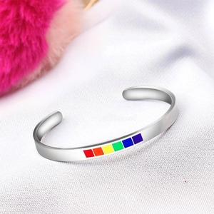 Detailed macro view of the rainbow inlay on silver stainless steel C-shaped open bracelet