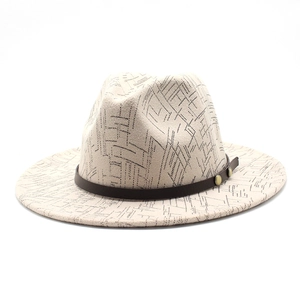 Detail of cream wool fedora featuring geometric black patterns and a brown leather band
