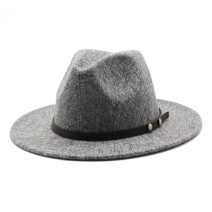 Detailed view of grey wool fedora hat with brown leather band and copper rivets