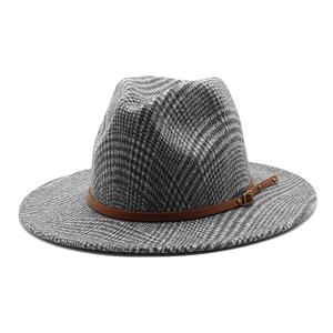 Close-up of wide brim wool fedora hat with plaid texture and leather buckle band