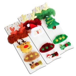 Three-piece Christmas hair clip set featuring plush reindeer, Santa, and tree designs