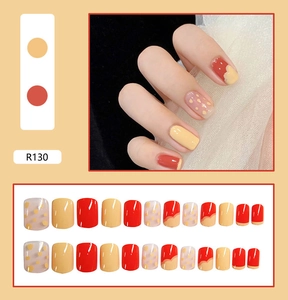 Short square press-on nails with yellow and orange patterns and 24-piece layout view