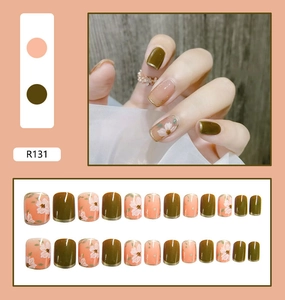 Detail view of salmon orange and olive green press-on nails with 24 pieces in various sizes