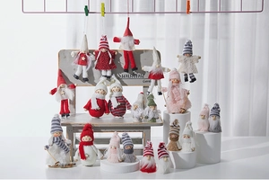 Close-up of assorted plush Christmas doll ornaments including Santa, Snowman and Elf characters